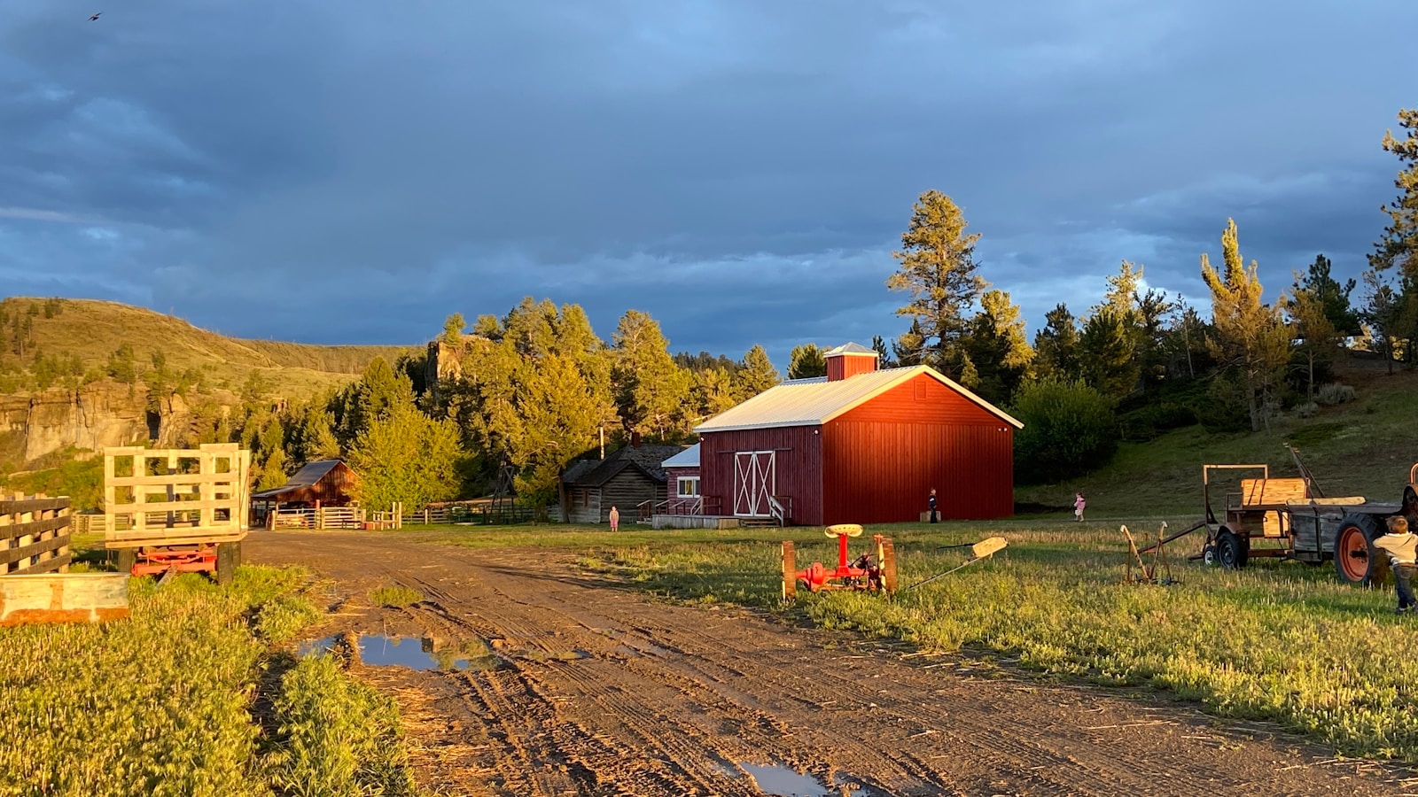 red wooden barn near green trees under white clouds during daytime, farm